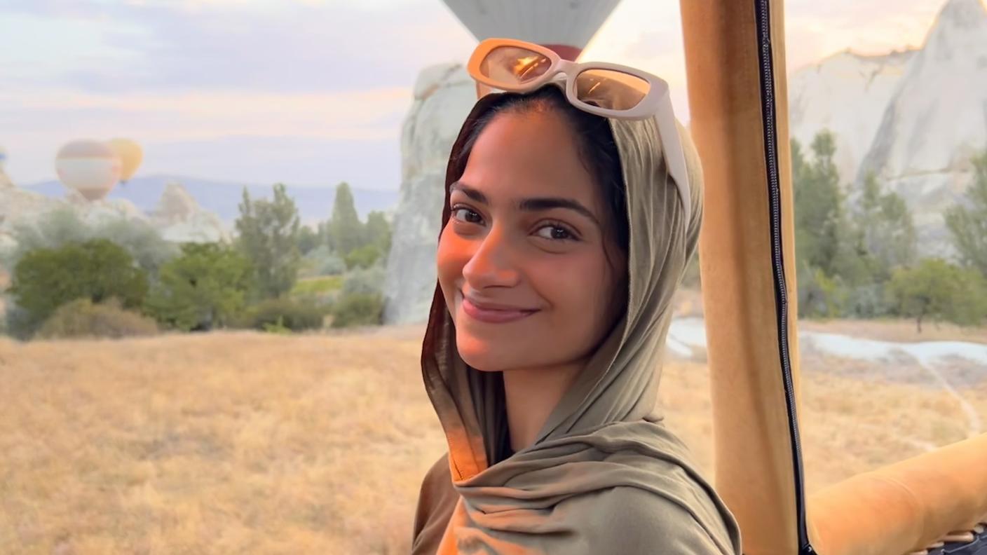 Picture of Yumnah, smiling while standing in a hot air balloon.